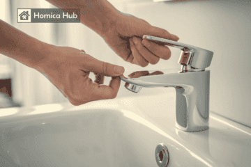 The image shows a man hands gripping and lifting a bathroom sink faucet handle that has been detached, exposing the faucet stem underneath.