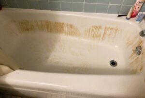 The image show hair dye stains in a bathtub.