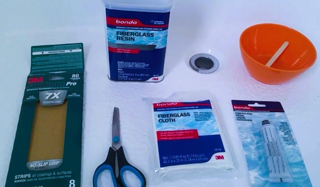 The image shows materials to repair a crack in a plastic bathtub.