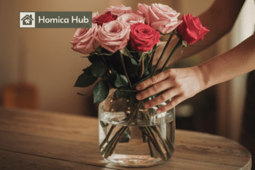 The image shows a man's hands holding a glass vase with sugar water In which roses of different colors are arranged.